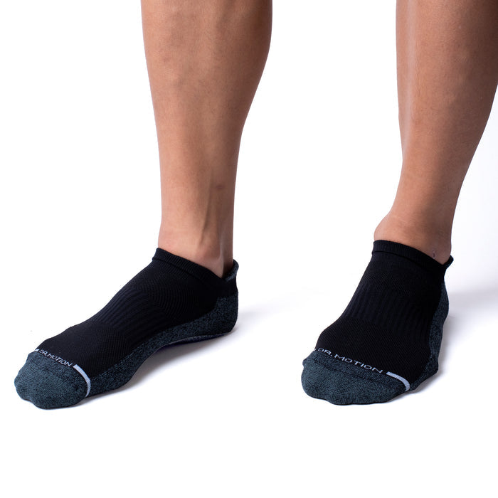 Black ankle compression socks with a textured gray toe and ribbed upper, worn on a person's feet.
