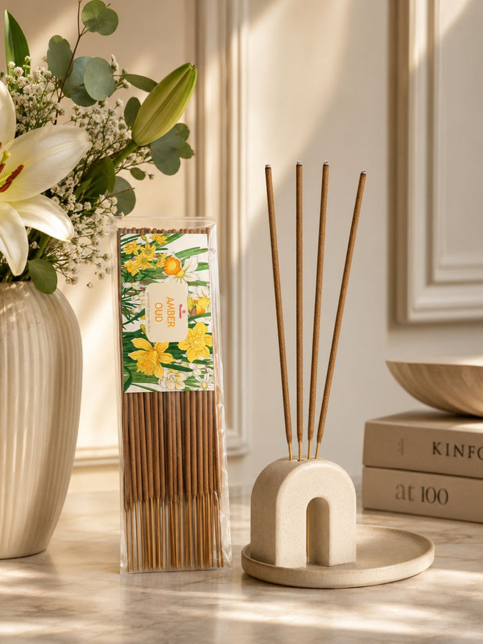 Amber oud incense stick pack with standing holder and several unlit sticks