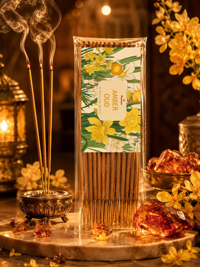 Amber oud incense sticks bundle and burning sticks on a brass holder