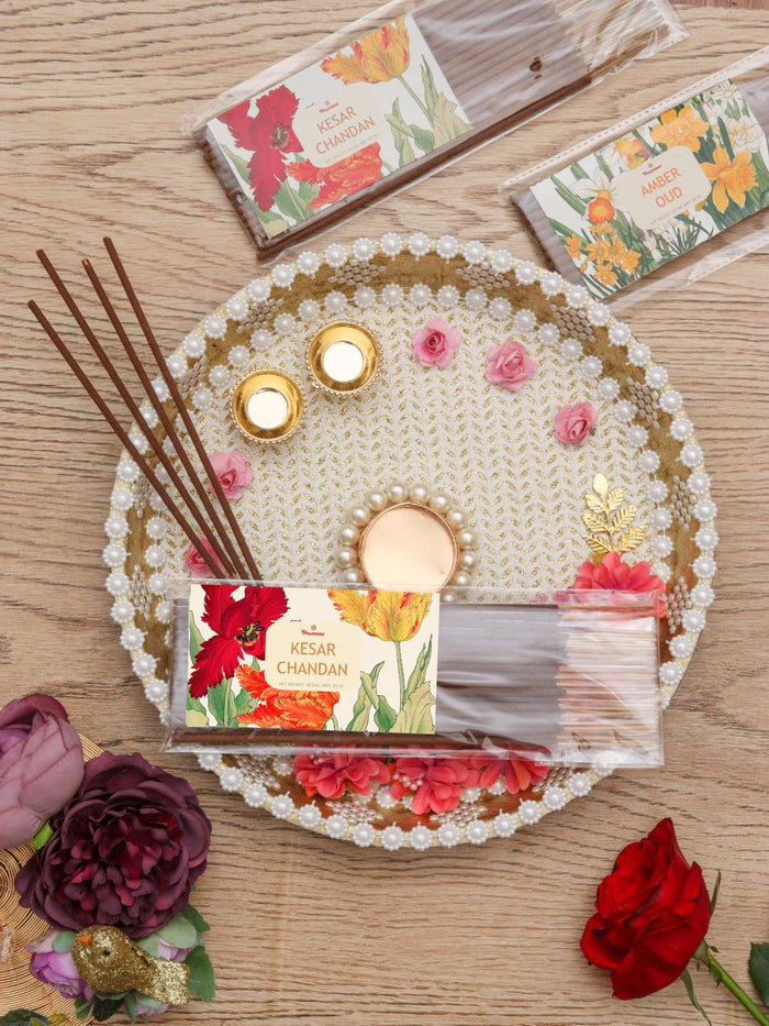 Agarbatti incense sticks in a pack with pearl floral decorative tray on wood