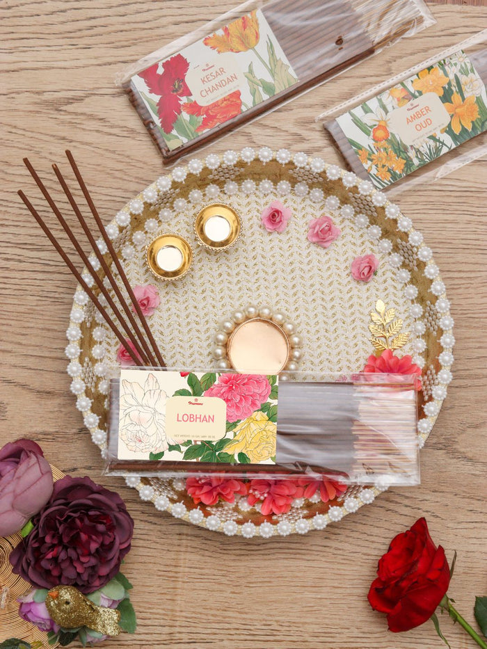 Floral incense stick pack on a decorative pearl-pattern tray with incense sticks