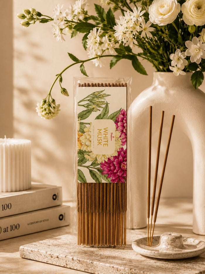 White musk agarbatti box with standing wooden incense sticks and small ash dish