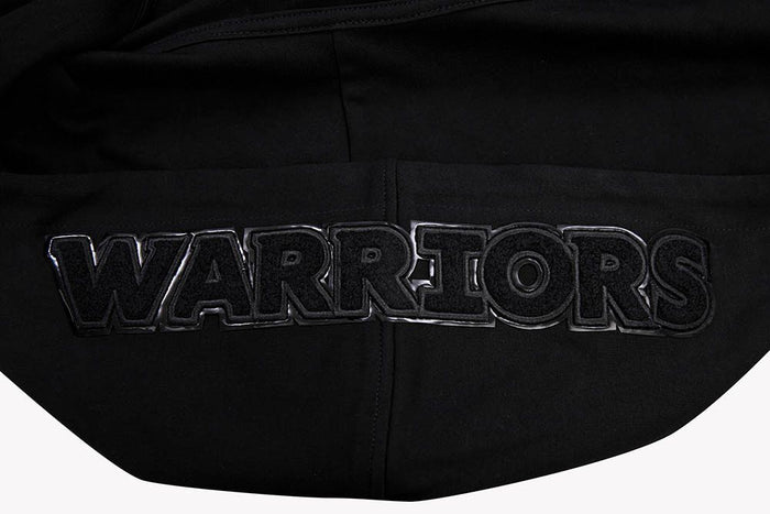 Side view highlighting the hoodie’s ribbed cuffs and waistband, emphasizing its classic fit and durable construction
