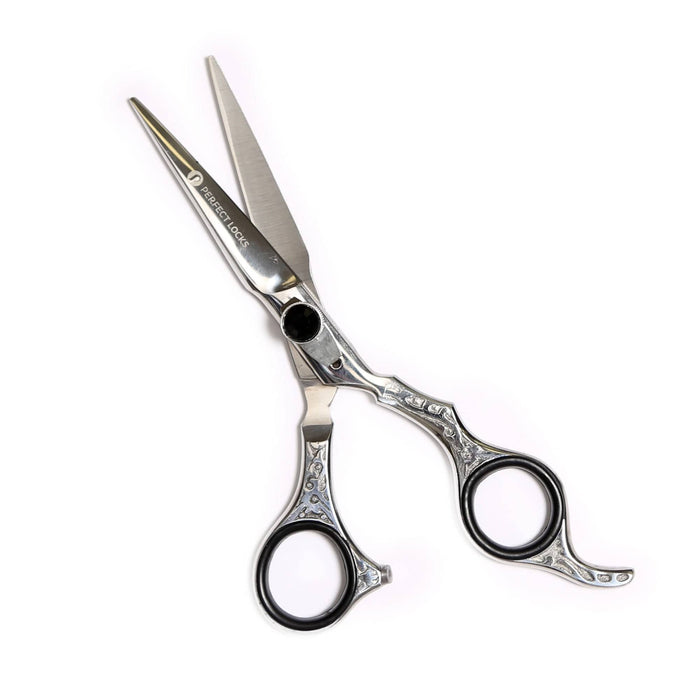 A pair of professional silver hair cutting scissors with ornate handles and precision blades, partially open, on a white background.