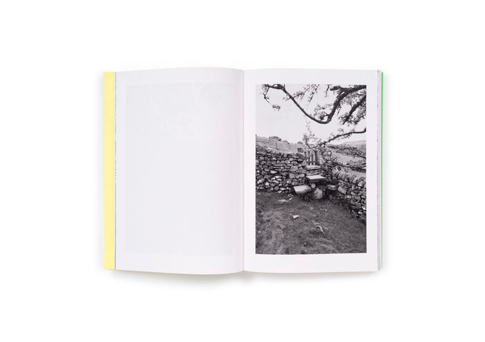 spread from interior of book, black and white picture of cobble stone wall