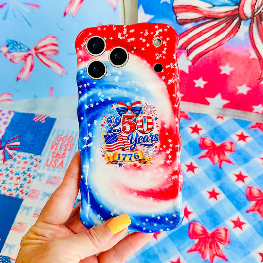 Trendy wavy iPhone case featuring a patriotic red, white, and blue marble swirl pattern covered in white stars with a central 250 Years 1776 flag emblem.