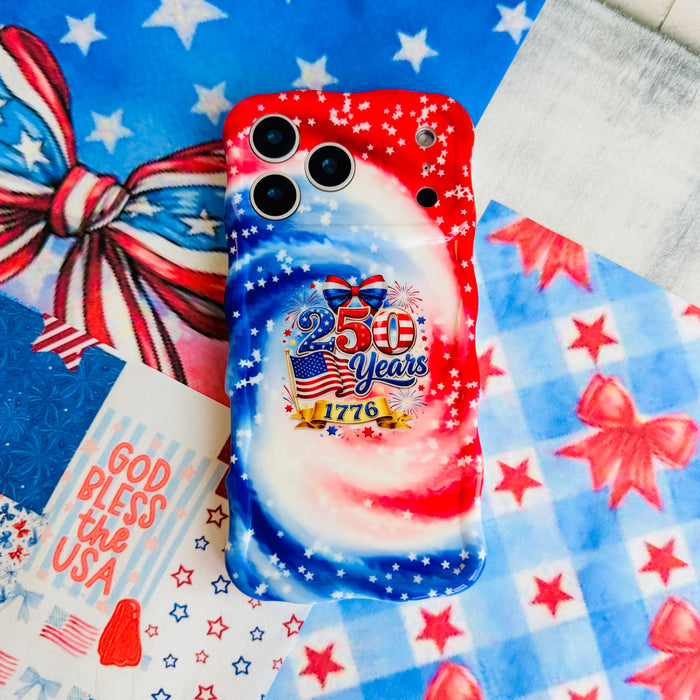 Trendy wavy iPhone case featuring a patriotic red, white, and blue marble swirl pattern covered in white stars with a central 250 Years 1776 flag emblem.