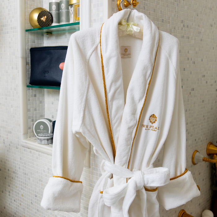 Plaza Hotel white robe hanging in the bathroom near the shower