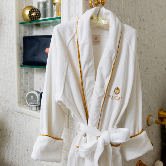 Plaza Hotel white robe hanging in the bathroom near the shower