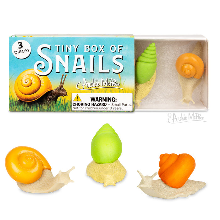 The Tiny Box of Snails showcases three bodaciously styled snail toys in orange and green, made from soft vinyl.